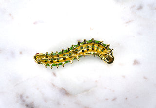 Enamel Caterpillar Brooch Pin. Designer: Kenneth Jay Lane Period: 1970s Dimensions: 3” Material: gold-tone metal, enamel Condition: Excellent  One of our favourite KJL designs, this caterpillar is delightful crawling just about anywhere: your shoulder, a hat, or up your sleeve. Beautifully made. Available at Fonfrege.com