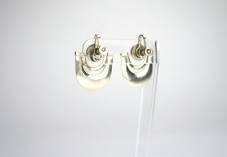 Designer: unknown (Taxco) Period: 1930s Dimensions: 1”x1” Material sterling Condition: Very good  A silver ball with two draping silver ribbon forms that swing, catching the light. Deceptively simple in design, these screw-back earrings are surprisingly light. Available at Fonfrege.com