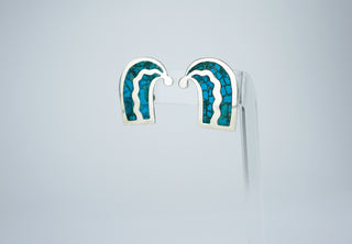 Designer: unknown (Taxco) Period: 1950s Dimensions: 1.25”x 75” Material: sterling, turquoise Condition: Very good  Resembling quotation marks, this pair of earrings features embedded turquoise fragments in silver. Screw back. Available at Fonfrege.com
